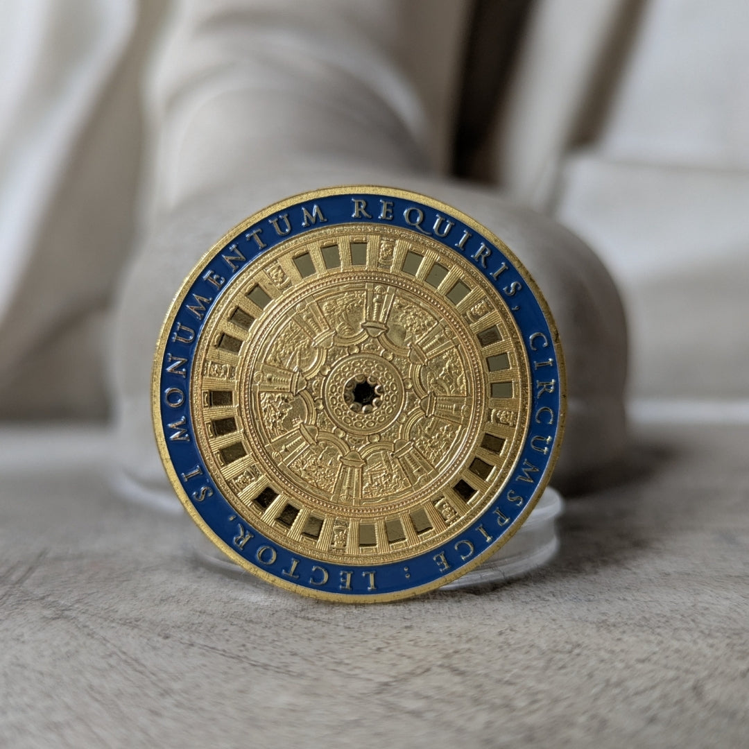 Decorative coin with intricate design and text on a neutral background
