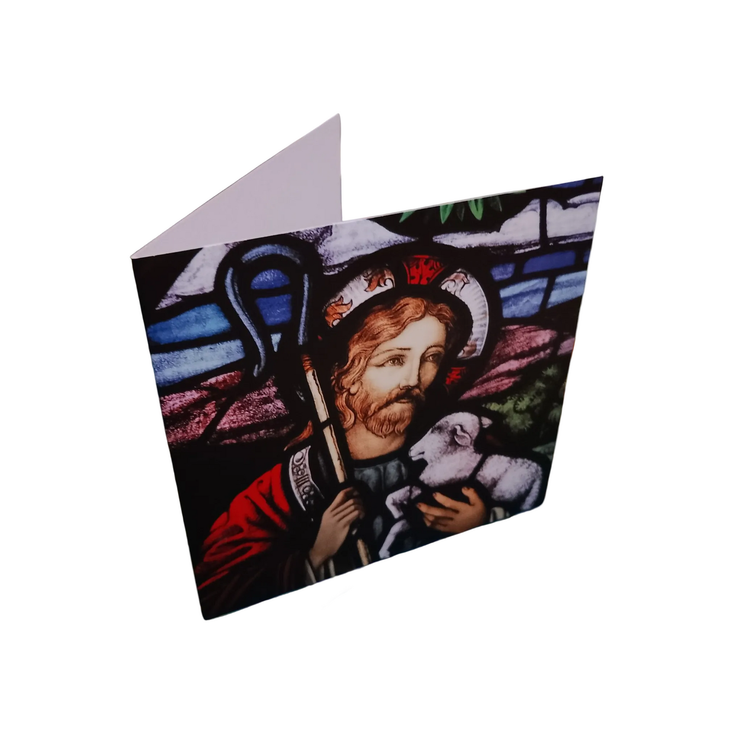 Greeting card with stained glass design featuring a religious figure holding a lamb on a white background.