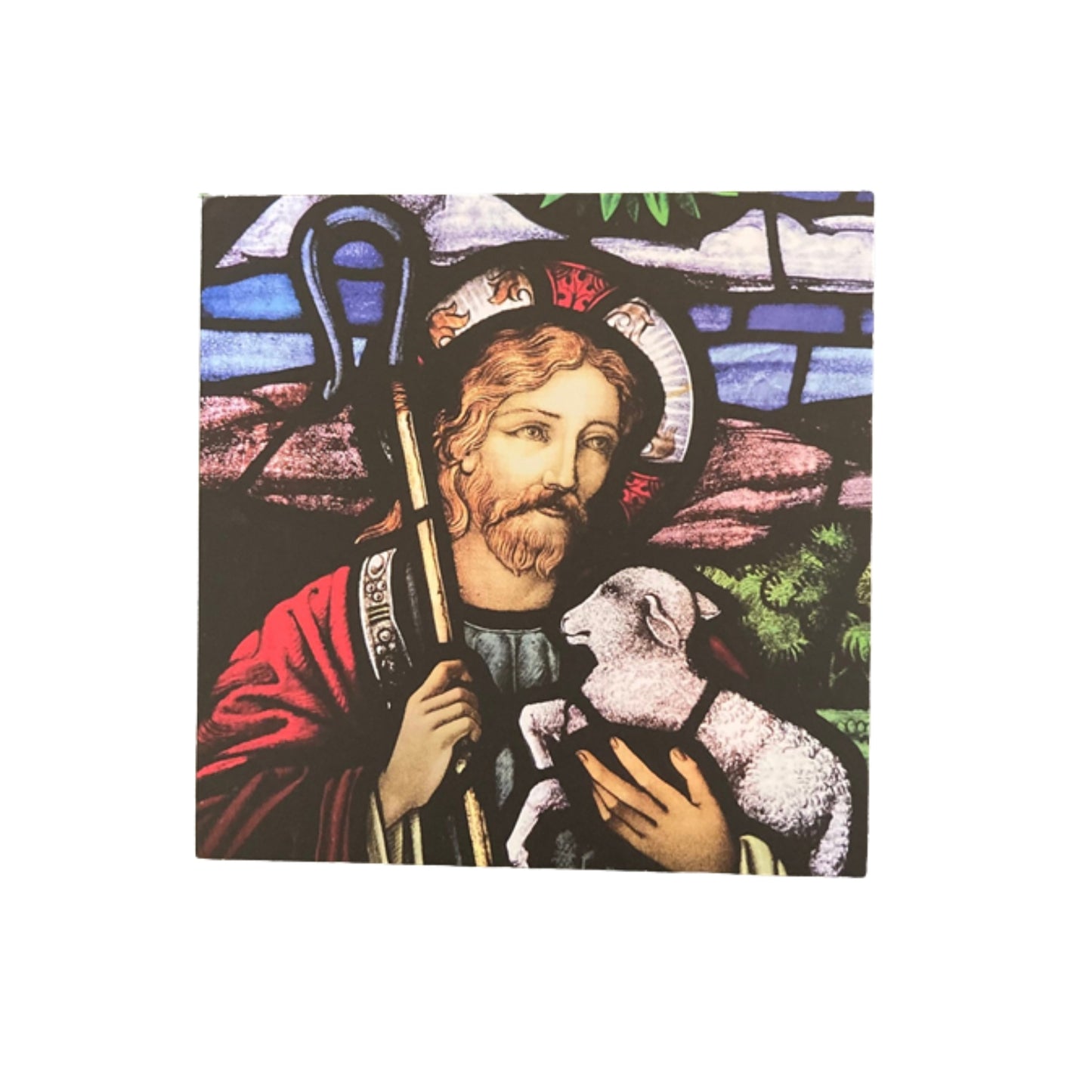 Stained glass window with a depiction of a robed figure holding a lamb on a white background